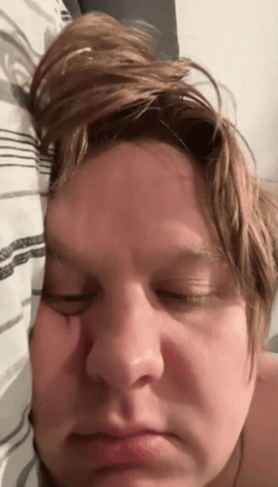 A Close Up Of A Person 'S Face With Their Eyes Closed And Their Hair Blowing In The Wind GIF