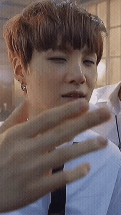 A Close Up Of A Person 'S Face With Their Eyes Closed And Their Hand Visible . GIF