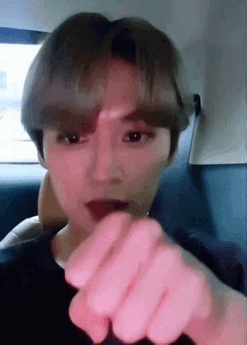 A Close Up Of A Person 'S Face With Their Finger Pointing To The Camera GIF
