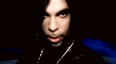 A Close Up Of A Person 'S Face With Their Hand In Front Of Their Mouth . GIF