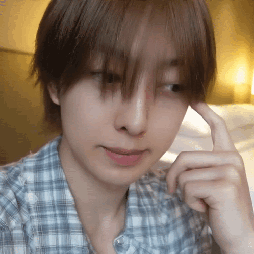 A Close Up Of A Person 'S Face With Their Hand On Their Chin GIF