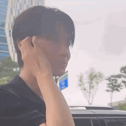 A Close Up Of A Person 'S Face With Their Hand On Their Face . GIF