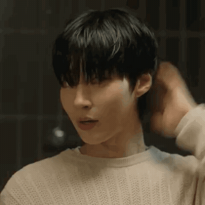 A Close Up Of A Person 'S Face With Their Hand On Their Hair . GIF