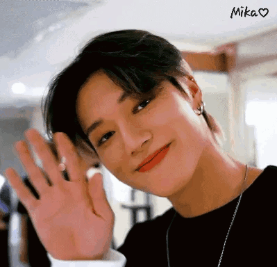 A Close Up Of A Person 'S Face With Their Hand Up . GIF