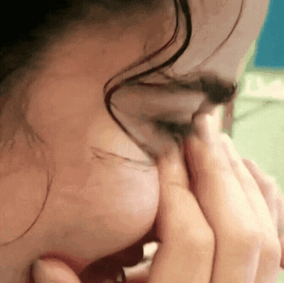 A Close Up Of A Person 'S Face With Their Hands On Their Face GIF