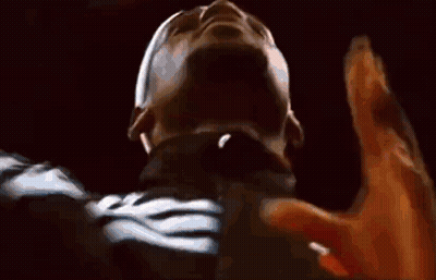 A Close Up Of A Person 'S Face With Their Hands Up In The Air . GIF