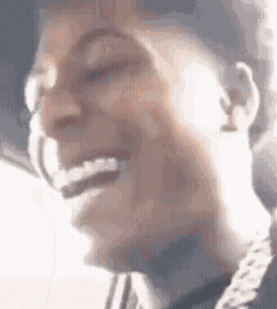 A Close Up Of A Person 'S Face With Their Mouth Open And A Chain Around Their Neck . GIF