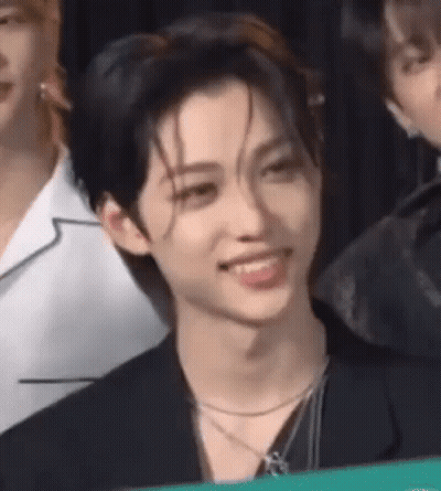 A Close Up Of A Person 'S Face With Their Mouth Open And A Necklace Around Their Neck . GIF