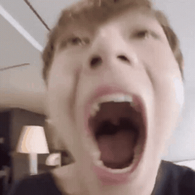 A Close Up Of A Person 'S Face With Their Mouth Wide Open . GIF