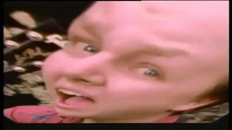 A Close Up Of A Person 'S Face With Their Tongue Hanging Out . GIF