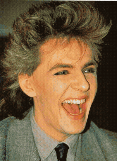 A Close Up Of A Person 'S Face With Their Tongue Sticking Out GIF