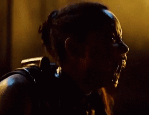 A Close Up Of A Person 'S Face With Water Coming Out Of It In The Dark . GIF