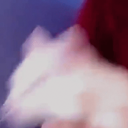 A Close Up Of A Person 'S Face With White Smoke Coming Out Of Their Mouth GIF
