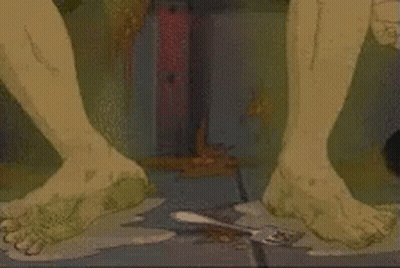 A Close Up Of A Person 'S Feet Standing On A Dirty Floor . GIF