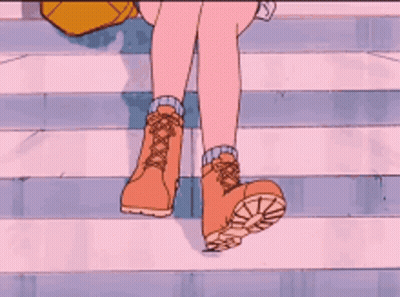 a close up of a person 's feet wearing brown boots