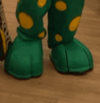 A Close Up Of A Person 'S Feet Wearing Green And Yellow Polka Dot Boots GIF