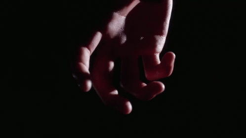 A Close Up Of A Person 'S Fist In A Black Glove GIF