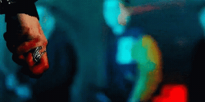 A Close Up Of A Person 'S Fist With A Ring On It In A Dark Room . GIF