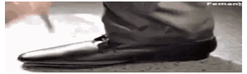 A Close Up Of A Person 'S Foot Wearing A Pair Of Black Shoes . Sticker