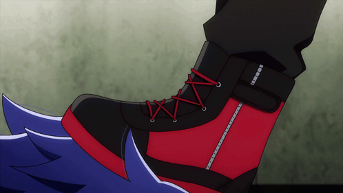 A Close Up Of A Person 'S Foot With A Black And Red Shoe With Red Laces GIF