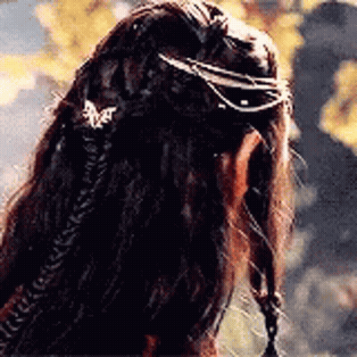A Close Up Of A Person 'S Hair With A Braid And A Ring On It . GIF