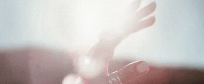 A Close Up Of A Person 'S Hand Holding A Bottle Of Water . GIF