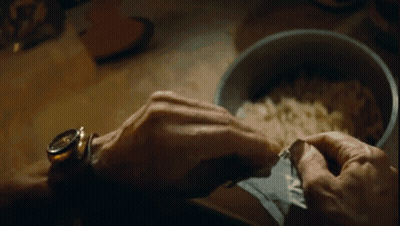 A Close Up Of A Person 'S Hand Holding A Bowl Of Food . GIF
