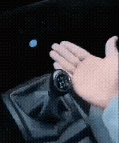 A Close Up Of A Person 'S Hand Holding A Gear Shifter GIF