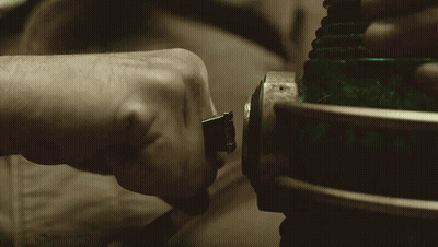 A Close Up Of A Person 'S Hand Holding A Green Lighted Object GIF