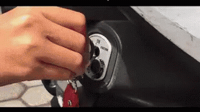 A Close Up Of A Person 'S Hand Holding A Key . GIF