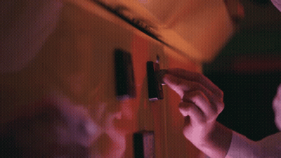 A Close Up Of A Person 'S Hand Holding A Lighter In A Dark Room GIF
