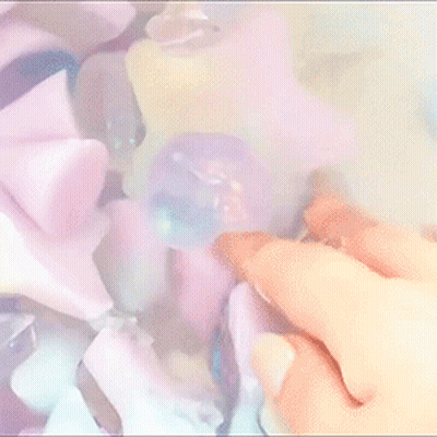 A Close Up Of A Person 'S Hand Holding A Purple Object GIF