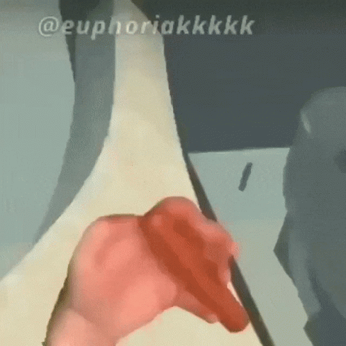 A Close Up Of A Person 'S Hand Holding A Red Object With The Words Euphoriakkkk Below It . GIF