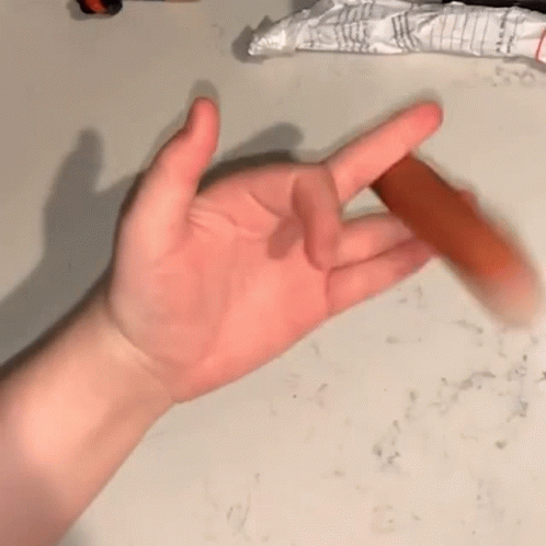 A Close Up Of A Person 'S Hand Holding A Stick GIF