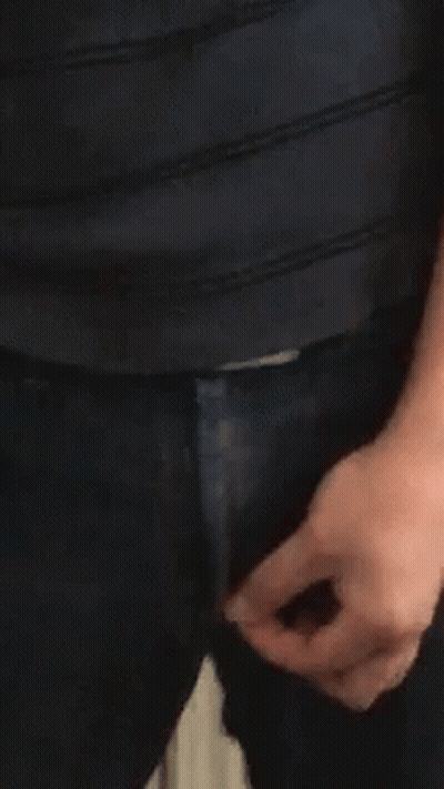 A Close Up Of A Person 'S Hand Holding A Zipper On A Pair Of Jeans GIF