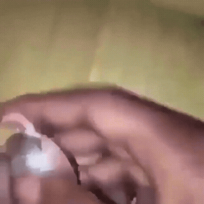 A Close Up Of A Person 'S Hand Holding Something In Their Hand . GIF