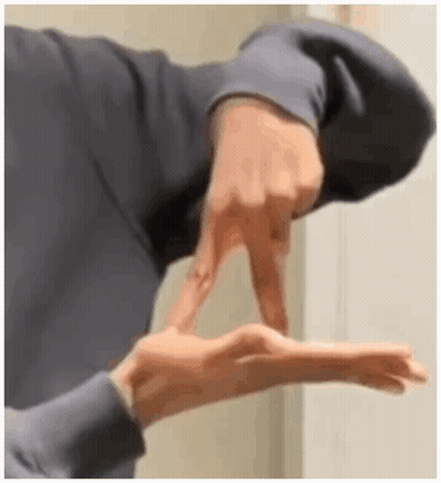 A Close Up Of A Person 'S Hand Making A Sign With Their Fingers . GIF