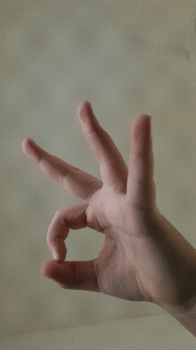 A Close Up Of A Person 'S Hand Making A Triangle GIF