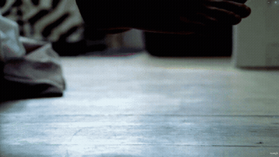 A Close Up Of A Person 'S Hand On A Wood Floor GIF