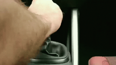 A Close Up Of A Person 'S Hand Pressing A Button On A Remote Control . GIF