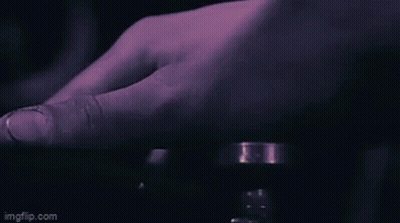A Close Up Of A Person 'S Hand Pressing A Button With A Purple Background . GIF