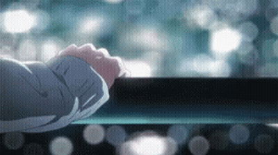 A Close Up Of A Person 'S Hand Reaching Out To Touch A Railing . GIF