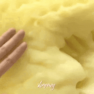 A Close Up Of A Person 'S Hand Touching A Yellow Blanket . GIF