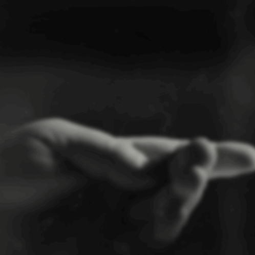 A Close Up Of A Person 'S Hand With A Black Background GIF