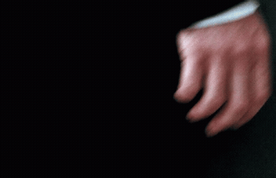 A Close Up Of A Person 'S Hand With A Black Shirt On GIF