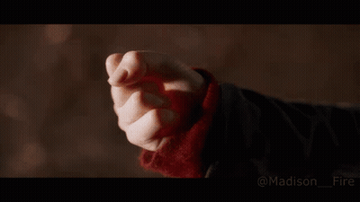 A Close Up Of A Person 'S Hand With A Fire Coming Out Of It . GIF