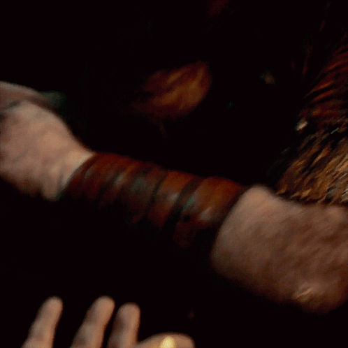 A Close Up Of A Person 'S Hand With A Gold Ring On It GIF