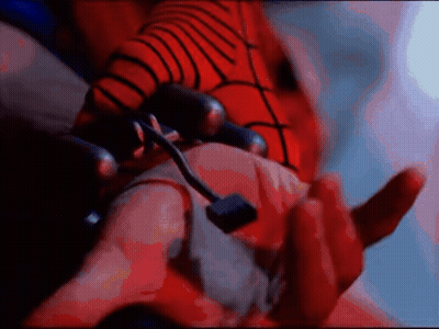 A Close Up Of A Person 'S Hand With A Red Spider Web On It GIF