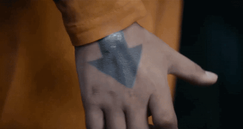 A Close Up Of A Person 'S Hand With A Tattoo Of An Arrow Pointing Upwards GIF