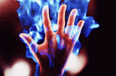 A Close Up Of A Person 'S Hand With Blue Flames Coming Out Of It 'S Fingers GIF